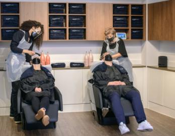 a group of people sitting in a chair talking on a cell phone