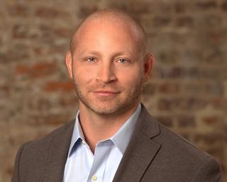 Christopher Lindstrom wearing a suit and tie