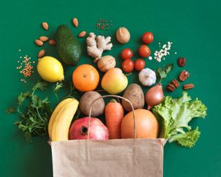 a box filled with fresh fruit and vegetables on display