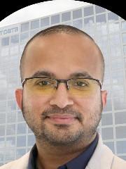 a man wearing glasses and looking at the camera