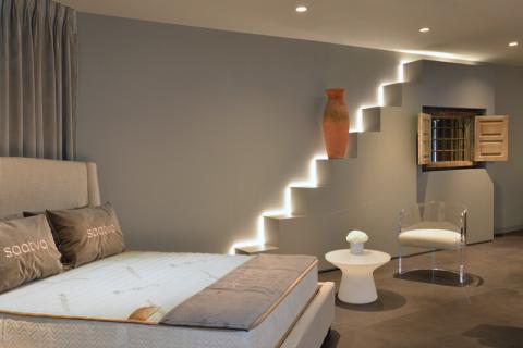 a bedroom with a bed and desk in a room