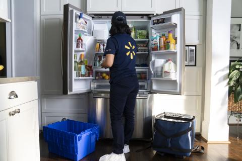 a person standing in front of a refrigerator