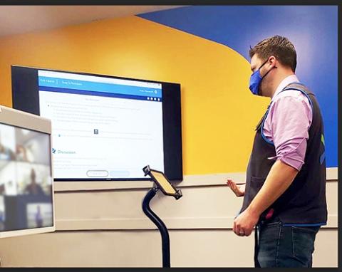 a man standing in front of a computer screen