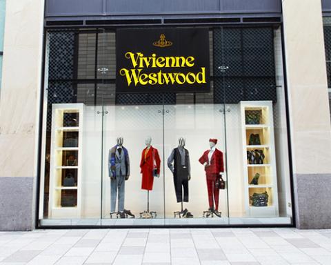 a group of people standing in front of a store