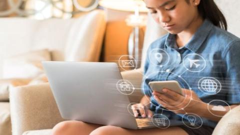 Girl looking at computer, purchasing online