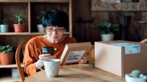 Woman making returns via mobile device