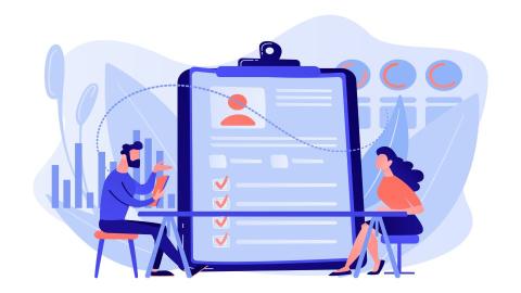Two people during an interview with a checklist