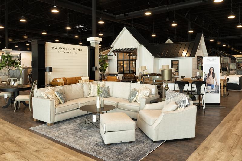 a room filled with furniture next to a building