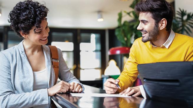 a man and a woman using a computer