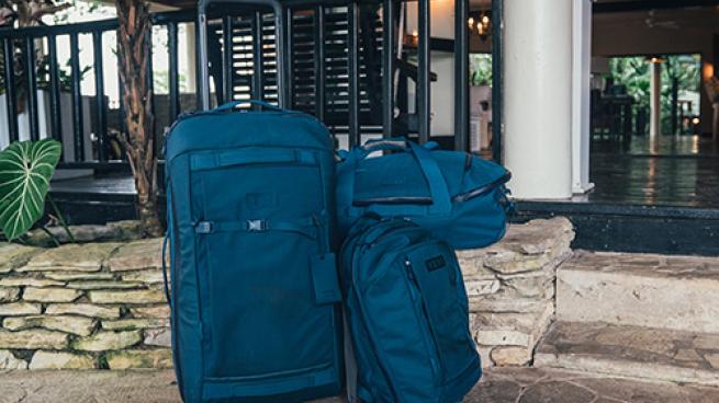 a bag of luggage sitting on the side of a building