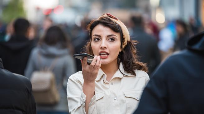 Alin Sumarwata talking on a cell phone