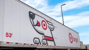 a truck with graffiti on the side of a road